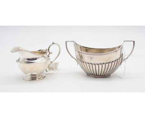 A Victorian silver sugar bowl, the body fluted, by William Hutton &amp; Sons, London 1894, and a silver cream jug, with an s 