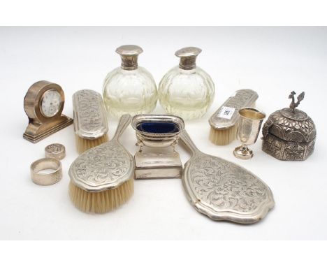 A collection of silver and white metal including a white metal vanity set, comprising a hand mirror, 2 clothes brushes, a hai