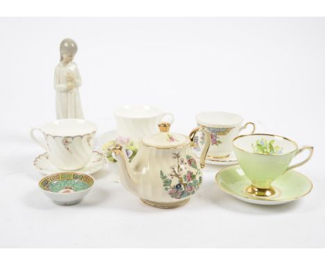 A miscellaneous collection of ceramics, including a Nao figure of a young girl, 20.5 cm high; a group of Chinese and Japanese