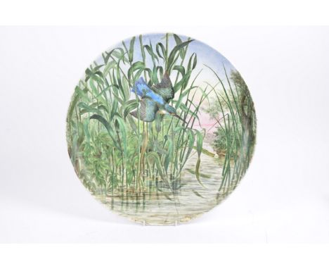A 19th Century hand painted ceramic charger by K.M. Marshall, decorated with a kingfisher amongst the reeds, signed lower rig