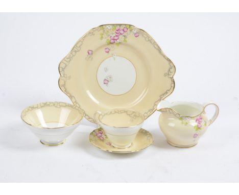 An early 20th Century Paragon tea service in the 'Elsie' pattern, consisting of twelve dessert plates, twelve saucers, eight 