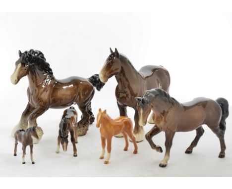 A collection of 15 Beswick porcelain models of horses, including Cantering Shire, no. 975, 22 cm high, Shire Horse, 21 cm hig