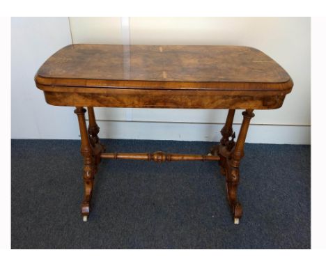 A Victorian burr walnut and inlaid card table, quarter veneered top with scroll inlay, hinged and swivel top revealing green 