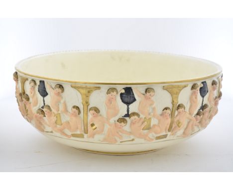 A 20th Century ceramic basin, exterior with relief moulding of putti, 39 cm diameter