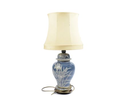 A modern Rochamp ceramic table lamp, baluster form, white tubelined floral decoration on blue ground, wooden base, cream shad