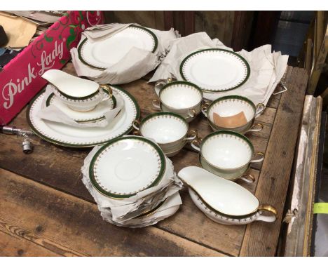 Aynsley green and gilt dinner service, including dinner plates, side plates, sauce boats, soup bowls and saucers, serving dis
