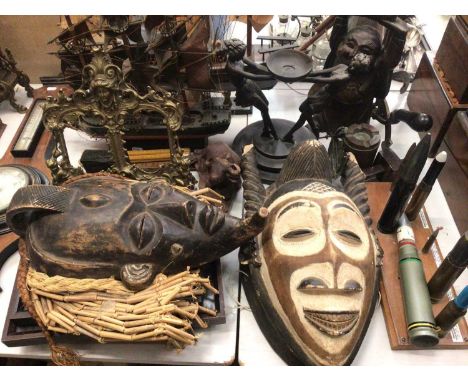 Two African carved wood masks, two wooden model ships, figure brass photograph frame, set of scales, two glazed frames contai