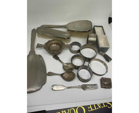 Group of silver to include a tea strainer, hand mirror, napkin rings etc, white metal fiddle pattern fork possibly with Colon