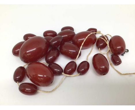 Two vintage simulated cherry amber bead necklaces (all loose)Oval beads- weighs approximately 48.3 grams in total. (Including