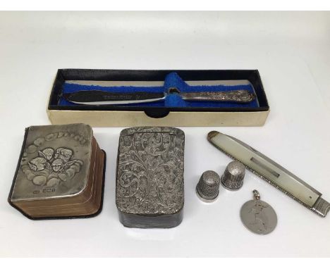 Silver mounted miniature Common Prayer book, two silver thimbles, silver football fob, silver and mother of pearl fruit knife