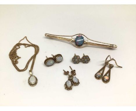 Group of 9ct gold and opal jewellery including a pendant on chain, four pairs of earrings and a yellow metal brooch set with 