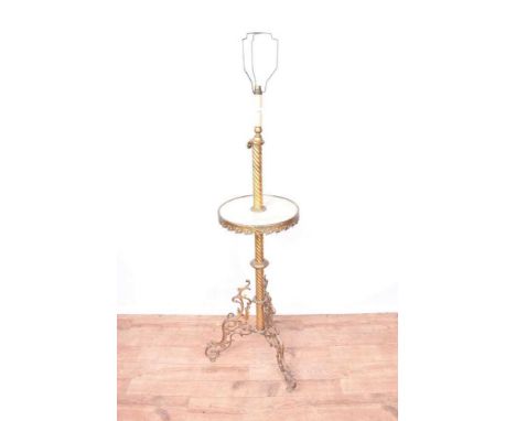 Early 20th century gilt metal and alabaster standard lamp, with spiral twist column and circular platform, raised on scrollin