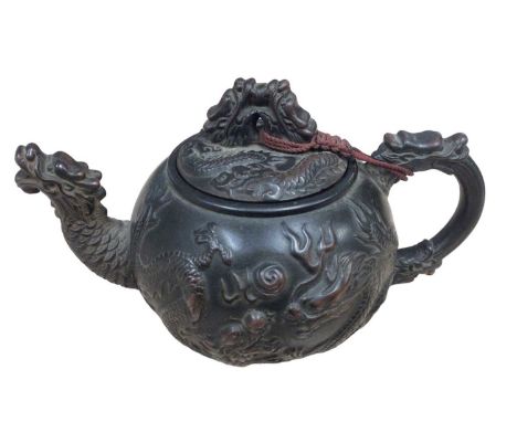 Chinese terracotta teapot of small proportions, with dragon decoration and seal mark to base. 13.5cm overall width
