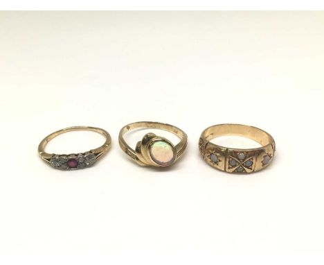 Three 14ct gold rings to include a diamond and ruby seven stone ring, size O½, opal single stone ring, size O and one other r