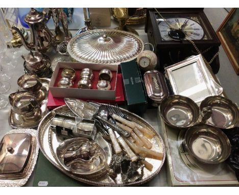 Group of silver plated ware, brass candelabrum, electric oil lamp, wall clock and other items