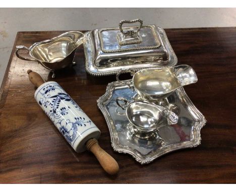 A Meissen-style blue and white onion pattern rolling pin, together with a silver plated entree dish and other silver plate