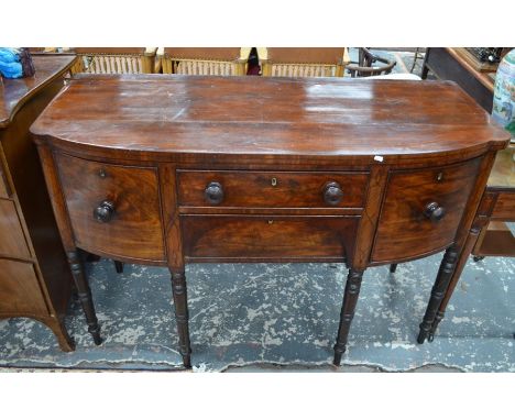 George III mahogany bow-front sideboard, the two centre drawers flanked by a cupboard and deep drawer with original turned pu