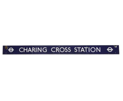 A London Transport enamel station sign for Charing Cross Station,with white lettering on a blue ground and two roundels at op