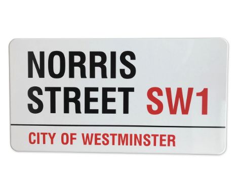 An enamelled iron street sign for Norris Street SW1, City of Westminster with iconic black and red sans serif lettering first
