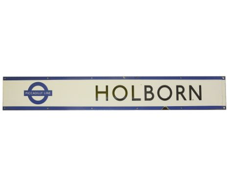 A London Underground enamel station frieze sign for Holborn,with black lettering on a white ground and blue edging and rounde