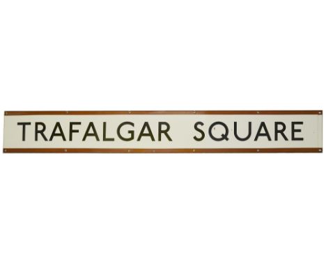 A London Underground enamel station frieze sign for Trafalgar Square,with black lettering on white ground and brown edging fo