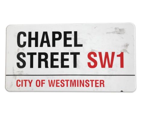 An enamelled iron street sign for Chapel Street SW1, City of Westminster with iconic black and red sans serif lettering first