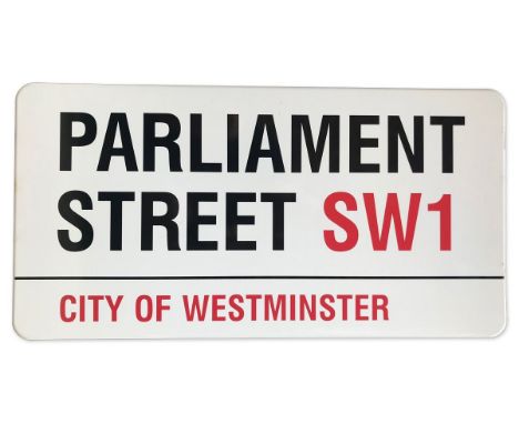 An enamelled iron street sign for Parliament Street SW1, City of Westminster with iconic black and red sans serif lettering f