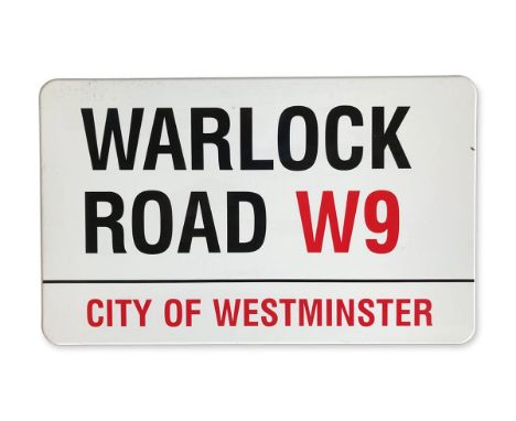 An enamelled iron street sign for Warlock Road W9, City of Westminster with iconic black and red sans serif lettering first c