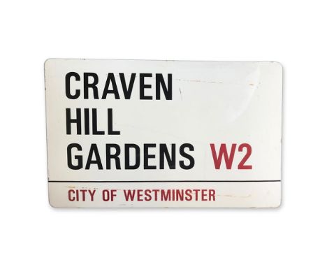 An enamelled iron street sign for Craven Hill Gardens W2, City of Westminster with iconic black and red sans serif lettering 