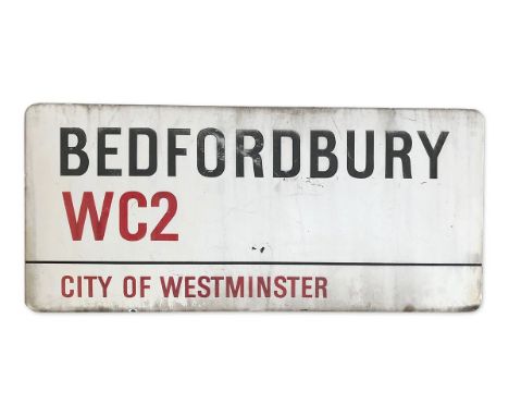 An enamelled iron street sign for Bedfordbury WC2, City of Westminster with iconic black and red sans serif lettering first c