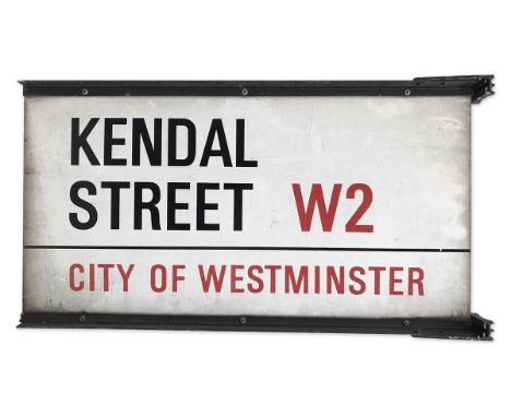 A double sided enamelled street sign on brackets for Kendal Street W2, City of Westminster with iconic black and red sans ser