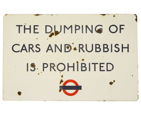 A London Transport enamel sign displaying 'THE DUMPING OF CARS AND RUBBISH IS PROHIBITED',blue lettering on white ground with