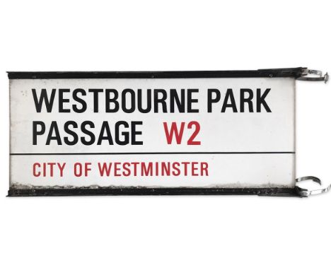 A double sided enamelled iron street sign on brackets for Westbourne Park Passage W2, City of Westminster with iconic black a