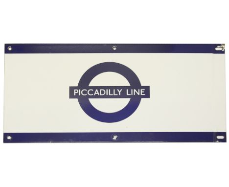 A London Underground enamel station frieze sign for 'PICCADILLY LINE',blue edging and roundel on white ground,height 24.5cm, 
