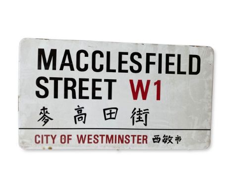 An enamelled iron street sign for Macclesfield Street W1 Chinatown, City of Westminster with iconic black and red sans serif 
