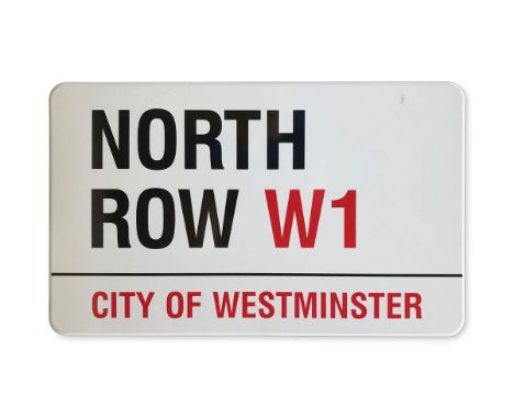 An enamelled iron street sign for North Row W1, City of Westminster with iconic black and red sans serif lettering first crea