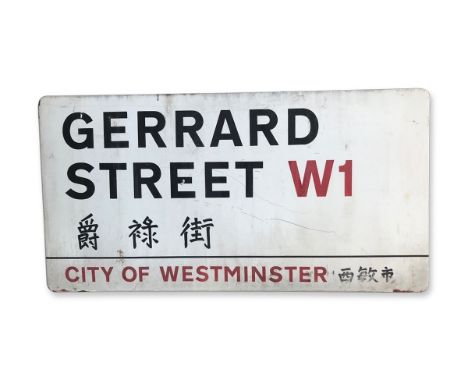 An enamelled iron street sign for Gerrard Street W1 Chinatown, City of Westminster with iconic black and red sans serif lette