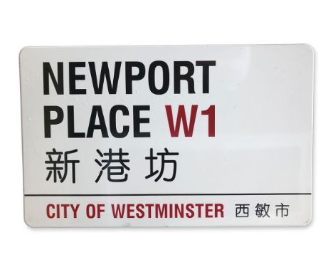 An enamelled iron street sign for Newport Place W1 Chinatown, City of Westminster with iconic black and red sans serif letter