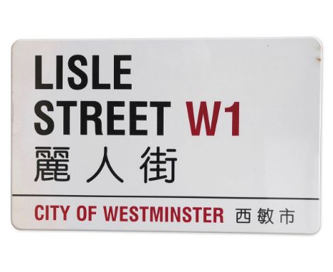 An enamelled iron street sign for Lisle Street W1, City of Westminster with iconic black and red sans serif lettering first c
