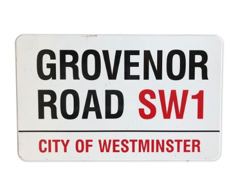 An enamelled iron street sign for Grovenor Road SW1, City of Westminster with iconic black and red sans serif lettering first