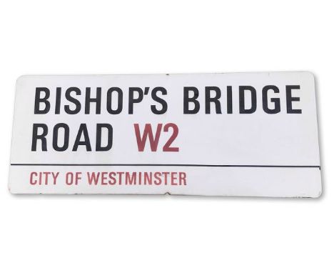 An enamelled iron street sign for Bishops Bridge Road W2, City of Westminster, with iconic black and red sans serif lettering