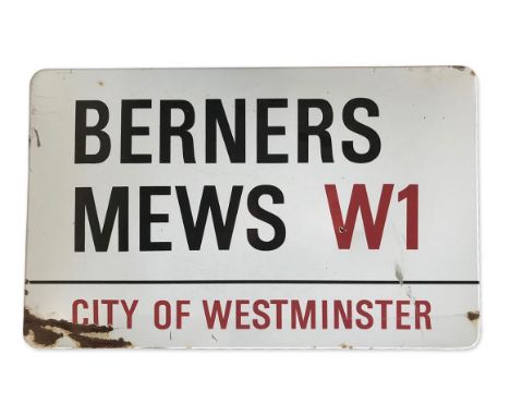 An enamelled iron street sign for Berners Mews W1, City of Westminster with iconic black and red sans serif lettering first c