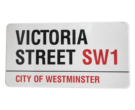 An enamelled iron street sign for Victoria Street SW1, City of Westminster with iconic black and red sans serif lettering fir