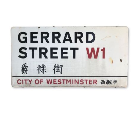 An enamelled iron street sign for Gerrard Street W1 Chinatown, City of Westminster with iconic black and red sans serif lette