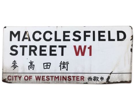 An enamelled iron street sign for Macclesfield Street W1 Chinatown, City of Westminster with iconic black and red sans serif 