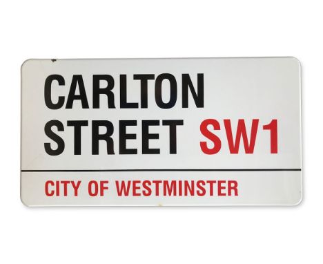 An enamelled iron street sign for Carlton Street SW1, City of Westminster with iconic black and red sans serif lettering firs
