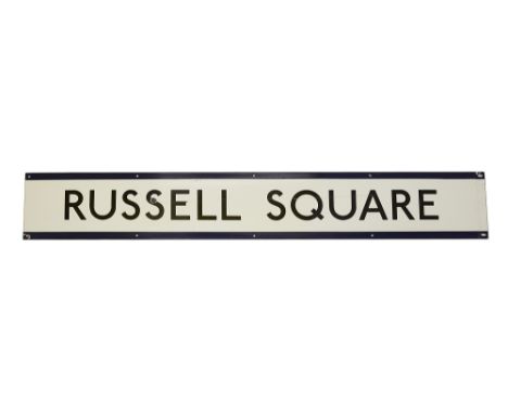 A London Underground enamel station frieze sign for Russell Square,black lettering on white ground with blue edging for the P