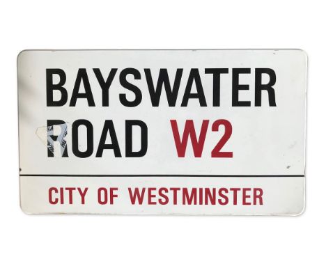 An enamelled iron street sign for Bayswater Road W2, City of Westminster with iconic black and red sans serif lettering first