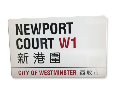 An enamelled iron street sign for Newport Court W1 Chinatown , City of Westminster with iconic black and red sans serif lette