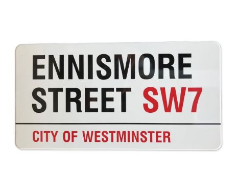 An enamelled iron street sign for Ennismore Street SW7, City of Westminster with iconic black and red sans serif lettering fi